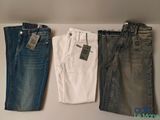 three pairs of men ' s jeans hanging on a clothes rack