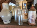 many vases and jars on a shelf in a room