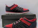 a pair of red and grey shoes sitting on top of a box