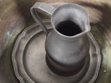 an image of a metal bowl with a cup on it