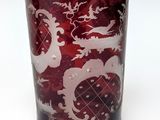 a red glass with a dragon design on it