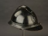 a silver helmet on a metal stand on a gray background