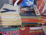 a lot of comic books sitting on a table