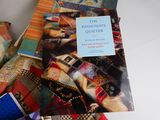 a book that is sitting on top of a pile of quilts