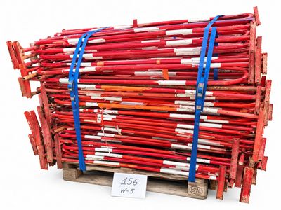 a pile of red sticks on a pallet with a price tag