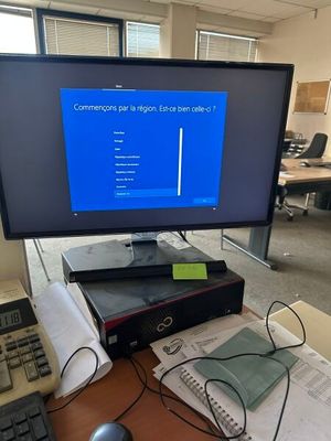 a computer monitor sitting on top of a desk next to a keyboard and mouse