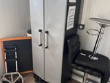 an image of a kitchen with a refrigerator and a chair