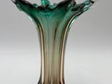 a glass vase that is sitting on a table
