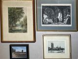 many pictures hanging on the wall above a toilet