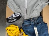 a box with a shirt, jeans, and a pair of shoes