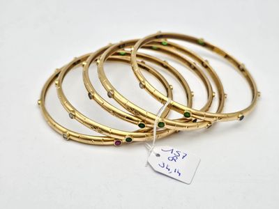 a close up of a stack of bangles with a tag on it