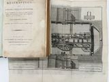 an open book with a drawing of a steam engine on it