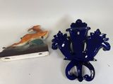 a picture of a blue vase and a book on a table
