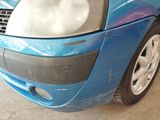 a close up of a car ' s front bumper with a blue paint job