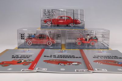 three red toy cars sitting on top of each other in a display case