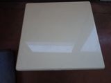 a white table with a glass top on a wooden floor
