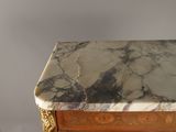 a marble top on the top of a wooden cabinet
