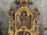 an ornate gold and red clock sitting on top of a wooden table