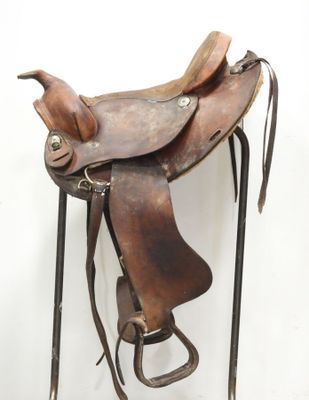 a brown saddle with a brown seat and a black handle