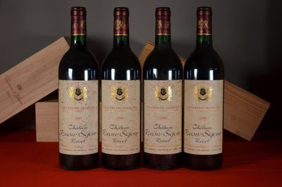 three bottles of red wine sitting on a table next to a wooden box