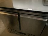 a stainless steel refrigerator in the corner of a kitchen
