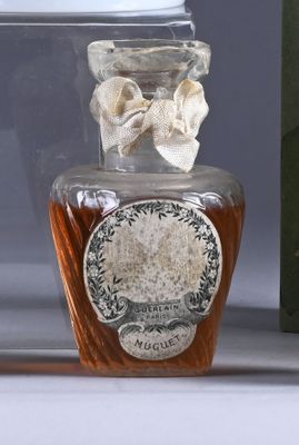 a bottle of liquor sitting on a table next to a book