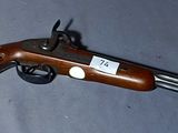 an old gun with a tag on it laying on a table