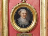portrait d'une femme dans un cadre doré sur fond rouge