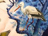two birds that are standing on a tree branch