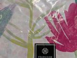 a picture of a pink shirt with a flower on it