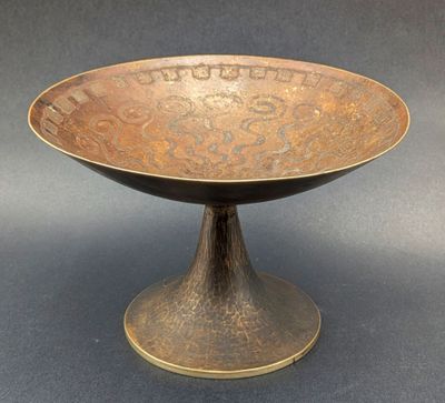 an antique bronze bowl with a decorative design on it