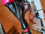 two vacuums that are sitting on the floor next to each other