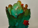 a glass vase with a cactus plant inside of it