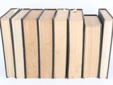 books stacked on top of each other on a white surface
