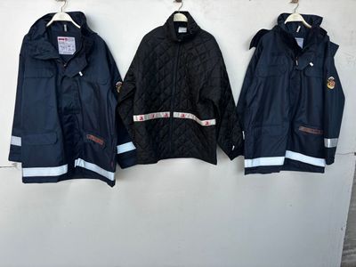 three jackets hanging on a wall next to each other