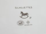 a white plate with a black horse on it