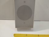 a speaker that is next to a ruler on a table