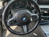 a steering wheel and dashboard of a bmw car