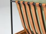 a wooden chair with a green cushion on top of it
