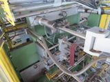 a machine that is working on pipes in a factory