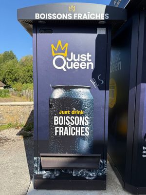 a vending machine that has a can of beer on it