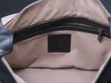 the inside of a black and white purse with a black handle