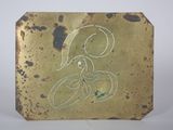 a gold plaque with a drawing of a woman on it