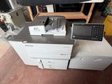 a pile of electronic equipment on a table in a room