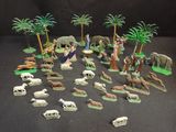 many figurines of animals and trees on the table