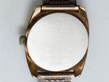a close up of a watch on a white surface