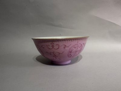 a purple bowl sitting on top of a white table
