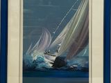 tableau encadré représentant un voilier sur une mer agitée, avec un cadre bleu