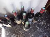 several bottles of wine are lined up on a table