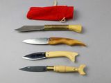 several knives are lined up in a row on a table